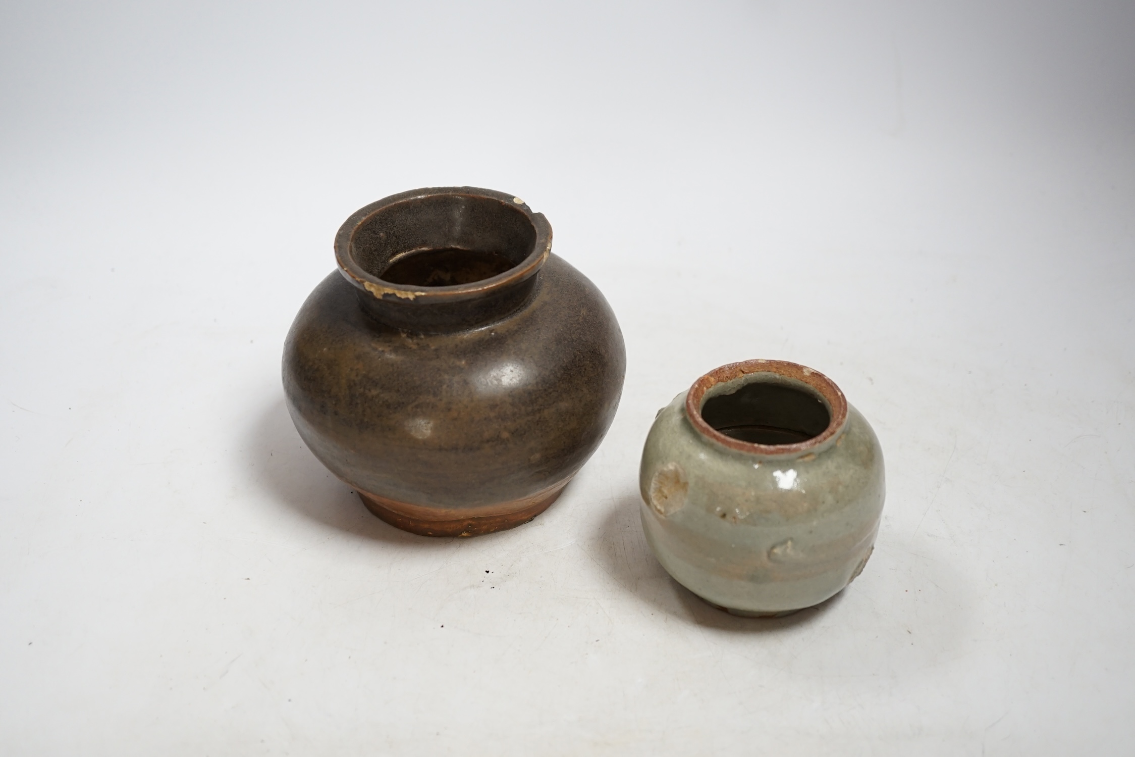 A Chinese brown partially glazed jar and a celadon jar, Song Dynasty largest 13cm in diameter